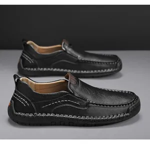 Detail of black leather men's loafers with visible handmade stitching and lychee texture