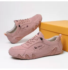 Detail showing high-quality gray-pink suede outdoor sneakers with sturdy stitching and wave sole