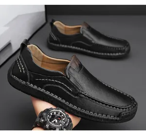 Close-up of black lychee leather men loafers with brown accents and hand-stitched details