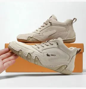 Close-up of beige suede high-top boots with durable rubber sole and lace-up design