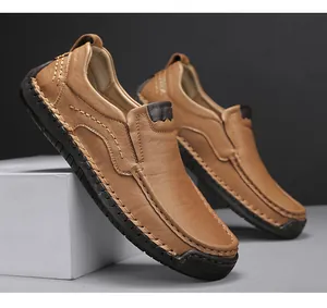 Close-up of handmade stitching on brown leather loafers with durable rubber sole