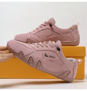 Detail of pink suede leisure shoes featuring moccasin stitching and non-slip rubber soles