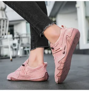 Macro detail of pink suede loafers with contrast stitching and non-slip rubber sole