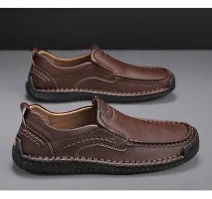 Macro detail of brown textured leather slip-on shoes with white stitching and rubber soles