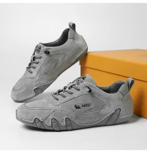 Detail view of grey nubuck leather outdoor sports shoes with DBECI logo and orange box