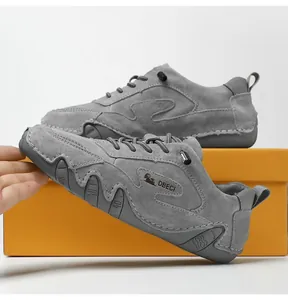 Detail of grey suede casual shoes featuring handmade stitching and non-slip rubber soles