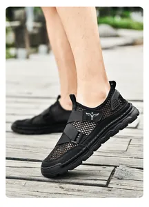 Close-up of black breathable mesh men's sandals with hook-and-loop strap outdoors