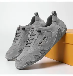 Detail of grey suede leather outdoor sneakers showing the non-slip sole and logo