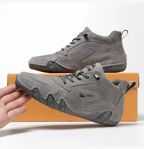 Detail of high-top grey leather sneaker with durable rubber sole and wavy anti-slip design