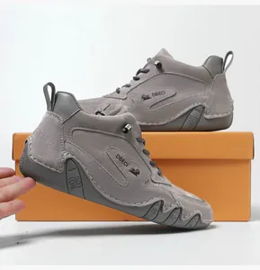 Detail of grey suede high-top leather boot featuring a wave-patterned non-slip rubber sole