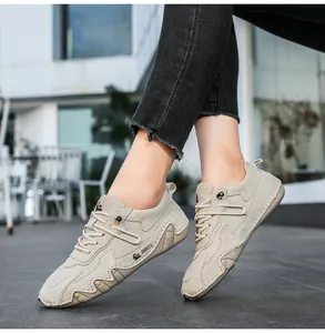 Macro shot of beige suede outdoor shoes with wave stitching and signature logo