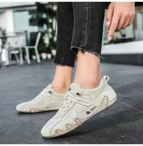 Close-up of beige leather outdoor shoe with hand-stitched details and rubber wave sole