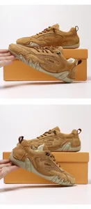 Detail of tan suede and mesh outdoor sneakers featuring wave-shaped rubber soles
