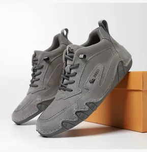 Detailed view of gray suede hiking boots with non-slip soles and brand logo
