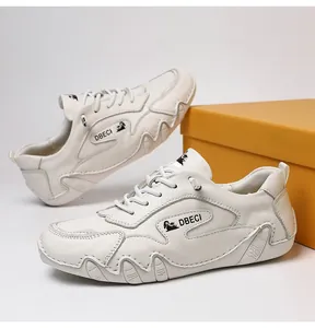 Detailed view of white leather casual sneakers with lace-up design and anti-slip rubber sole