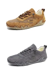 Detail view of breathable mesh and suede upper on casual outdoor sneakers in brown and grey