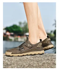 Detail of men's brown mesh sandals featuring velcro straps and anti-slip rubber soles