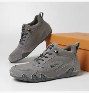 Close-up of high-top leather sneakers featuring durable grey suede and non-slip rubber soles