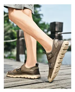 Close-up of breathable khaki mesh sandals with durable non-slip soles on a wooden path