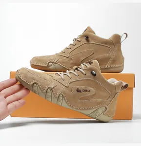 Detail shot of brown suede lace-up boots with non-slip sole and DBECI branding logo