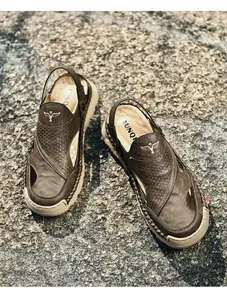 Detail of men's leather sandals featuring breathable perforations and hand-stitched soles