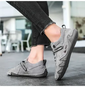 Macro detail of grey genuine leather outdoor leisure shoe showing premium stitching and texture
