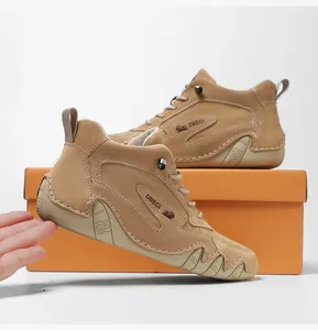 Detail of high-top khaki suede leather boots with non-slip rubber sole and shoebox