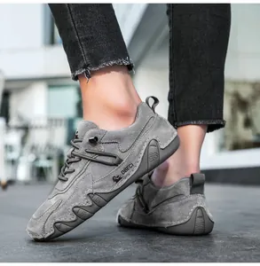 Detail of grey suede hiking shoe featuring premium stitching and durable rubber sole