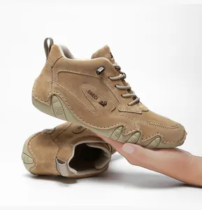 Detailed side view of khaki suede leather high-top sneakers with durable rubber soles