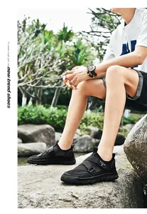 Detail of black breathable mesh sandals for men featuring adjustable velcro straps and wing logo