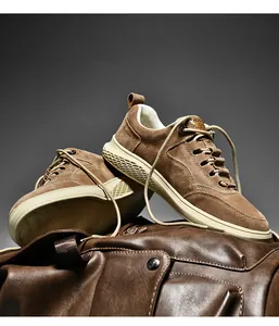 Detailed view of men's brown suede sneakers with textured honeycomb pattern midsoles