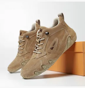 Macro detail of high-top leather casual boots featuring khaki suede and durable rubber sole