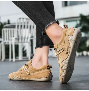 Detail of khaki suede leather outdoor shoe featuring wrap-around anti-slip rubber outsole