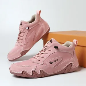 Pink high-top women's leather sneakers with rugged rubber soles and lace-up design
