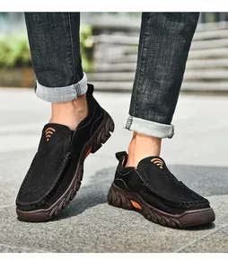 Detail of men's black nubuck leather slip-on shoes with thick brown non-slip rubber soles