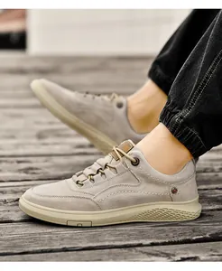 Detailed side view of men's beige casual low-top sneakers with honeycomb texture sole