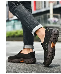 Detail of men black slip-on sneakers with brown thick rubber soles and anti-slip tread