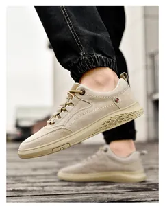 Close-up of khaki canvas casual shoe featuring detailed stitching and rubber sole side