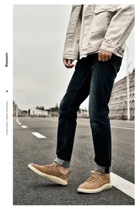 Close-up of brown suede casual sneakers with thick white soles on outdoor street