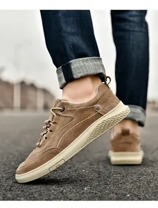 Detail of tan casual shoes featuring white contrast stitching and honeycomb textured sole