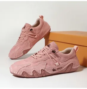 Detailed macro view of pink suede casual sneakers with DBECI logo and wave rubber sole
