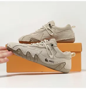 Detailed side view of beige suede outdoor leisure shoes with non-slip wavy rubber soles