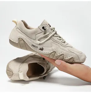 Detail of hand-stitched beige suede leather outdoor shoes with anti-slip rubber soles