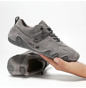 Close-up of grey suede leather sneaker featuring DBECI logo and non-slip rubber sole
