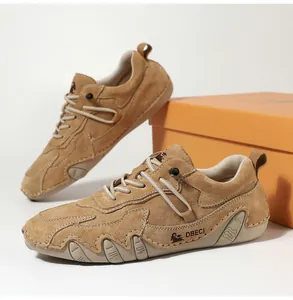Detail of khaki suede leather shoes with heavy manual stitching and durable rubber sole