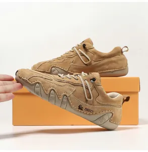 Close-up of brown suede leather outdoor sneaker featuring durable hand-stitched detailing