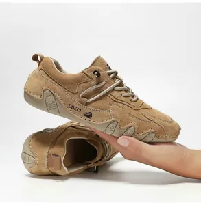 Macro detail of men's brown genuine leather casual shoes with hand-stitched seams and logo