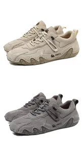 Detail view of suede leather hiking shoes featuring precision stitching and wave-grip soles