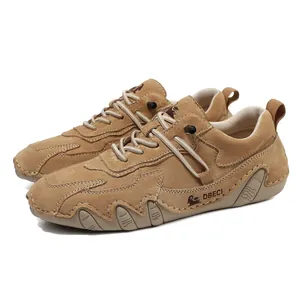 Close-up of premium brown suede outdoor shoe featuring durable wavy rubber sole and logo