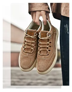 Detail showing brown suede texture and white stitching on high-top casual men's sneakers